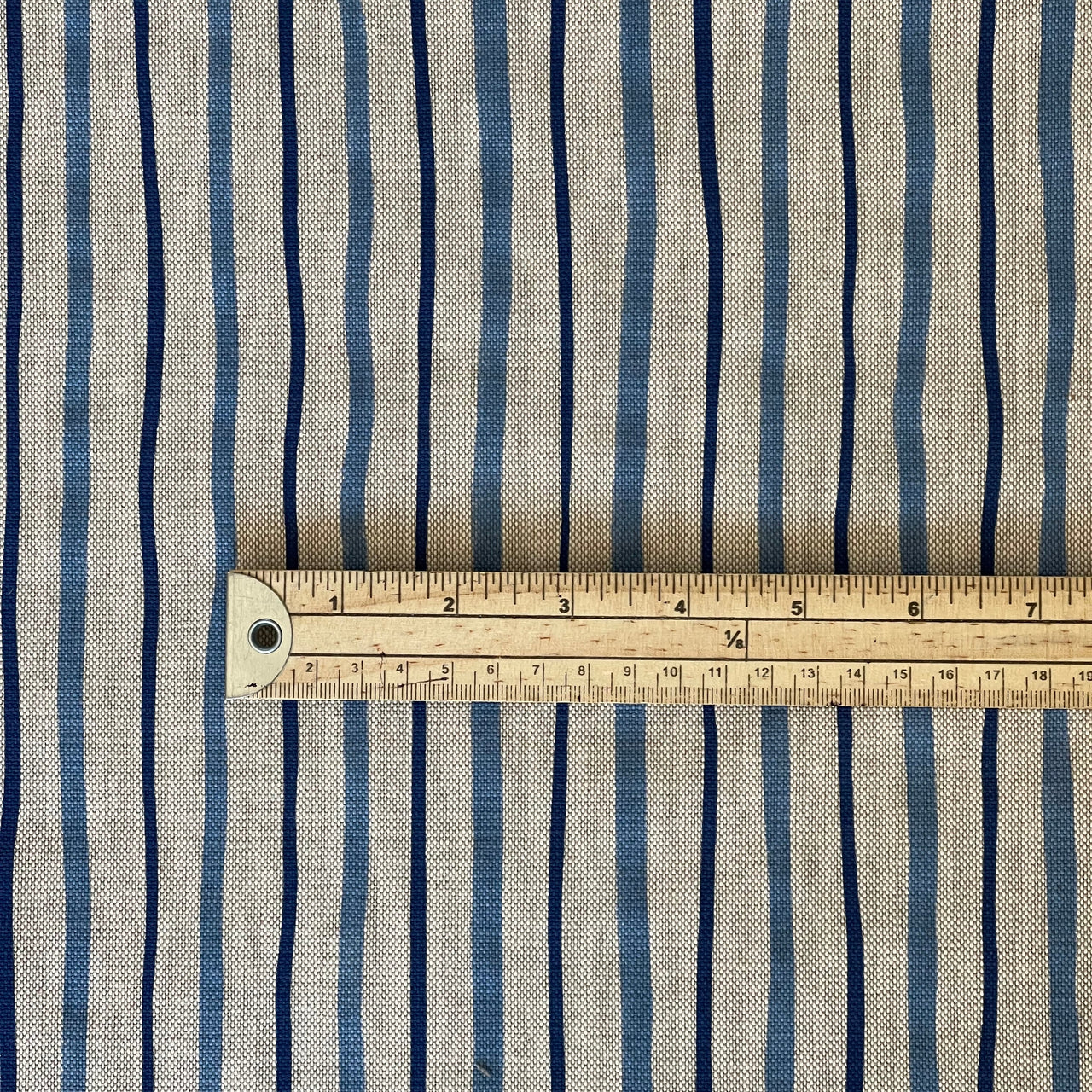 Close-up of the blue stripes and woven beige texture of Seabreeze fabric