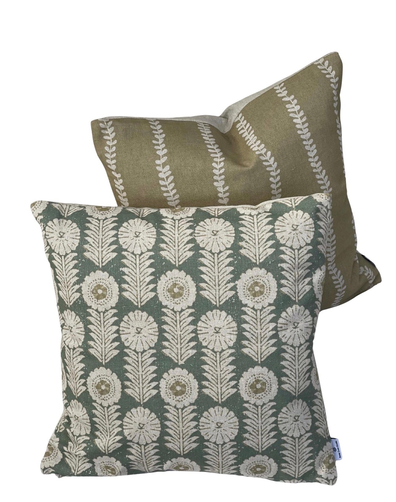 Close-up of soft gold linen-look cushion cover featuring vertical cream botanical leaf stripes
