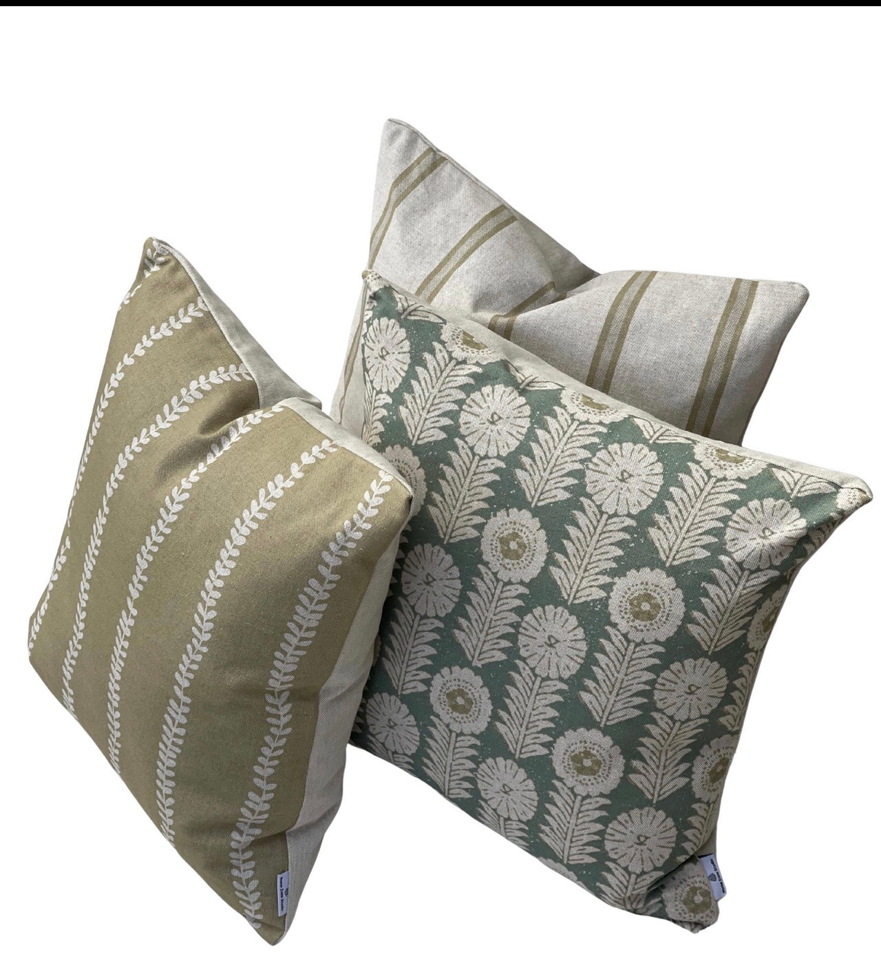 Soft gold stripe cushion cover styled with Apple Green floral and ticking stripe cushions in a neutral living room