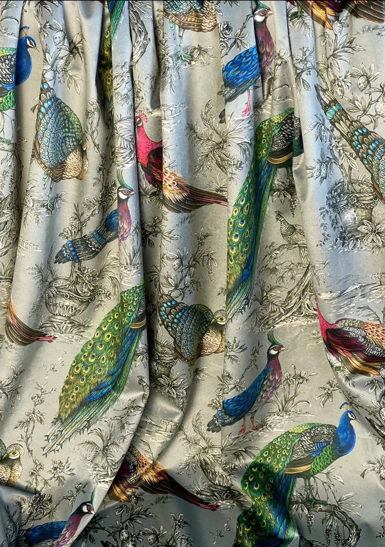 Designer velvet curtain fabric with peacock and pheasant motif, sold by the metre for luxury home décor projects.