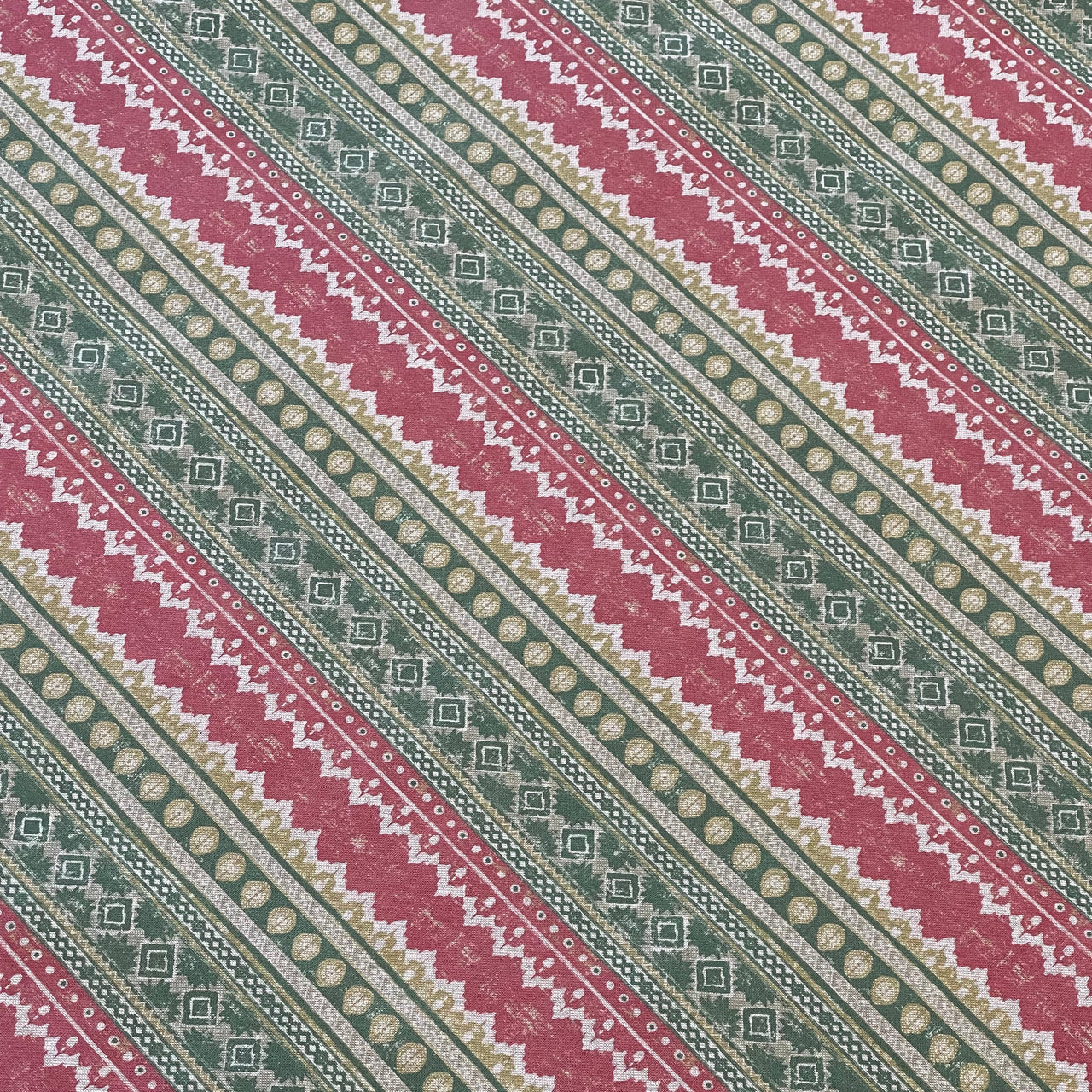 Patterned fabric with red and green stripes on a diagonal