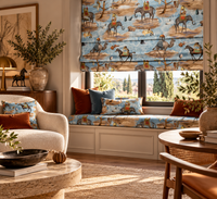 Thumbnail for Artistic reading nook featuring a blue surrealist animal print Roman blind, coordinating window-seat cushion and pillows with warm neutral furnishings.