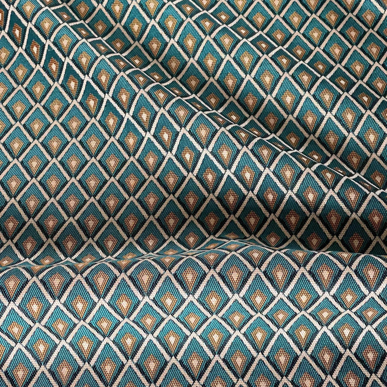 Full-width view of teal blue geometric jacquard curtain fabric