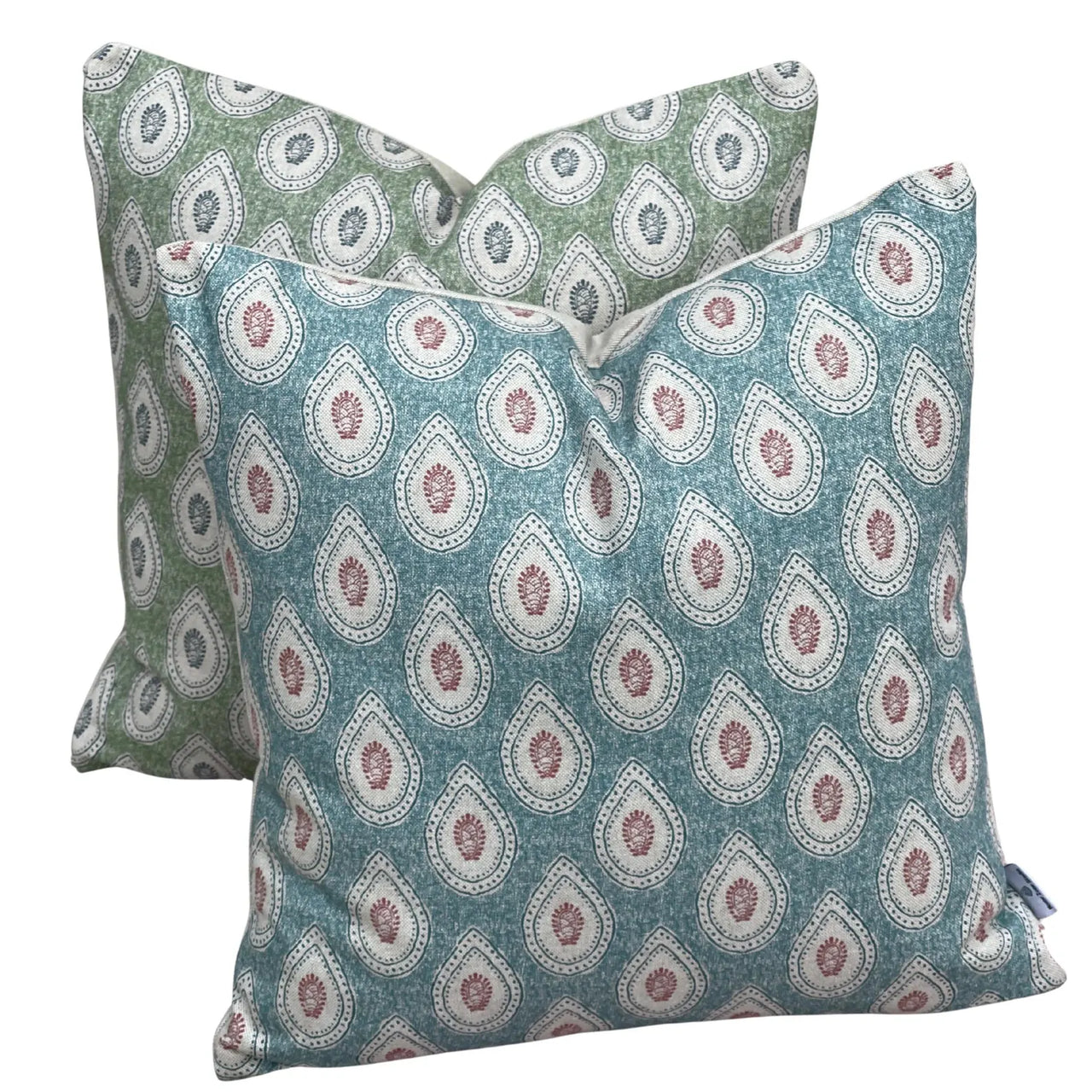 Coordinated teal and sage green paisley cushion covers with ivory teardrop patterns displayed together