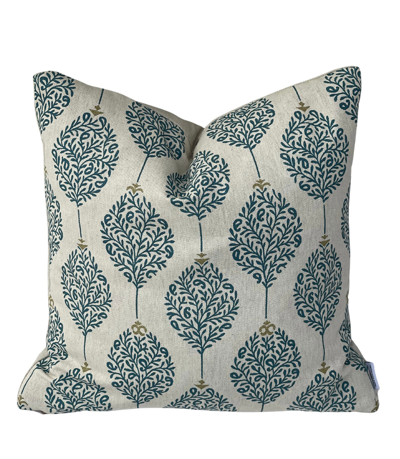 Linen-look cushion cover with teal leaf pattern on a warm natural neutral background.