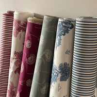 Thumbnail for Rolls of fabric with various patterns on a neutral background