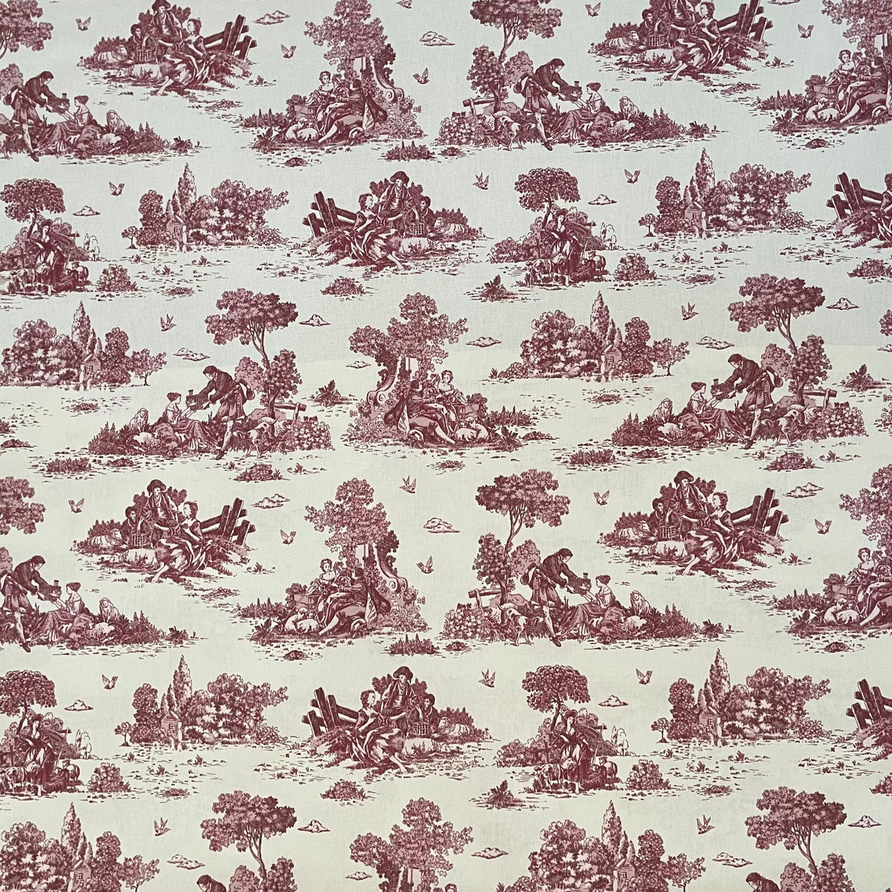 Patterned fabric with red and green design on a light background