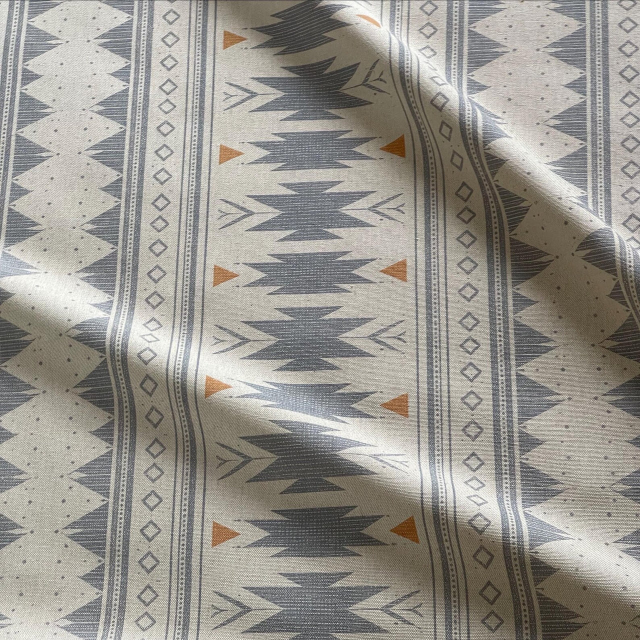 Aztec pattern fabric in soft blue grey with vertical stripe design