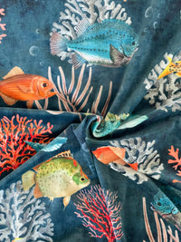 Thumbnail for Close-up of fabric with fish and coral pattern on a dark blue background