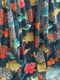 Thumbnail for Stack of fabric with fish and coral pattern on a dark blue background
