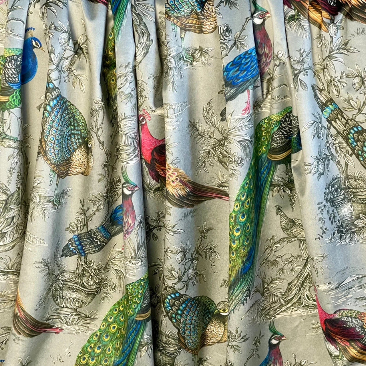 Statement peacock velvet material with rich jewel colours on soft silver background for drapery and cushions.