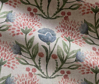 Thumbnail for Close-up of blue and blush pink meadow flowers with green leaves on natural fabric