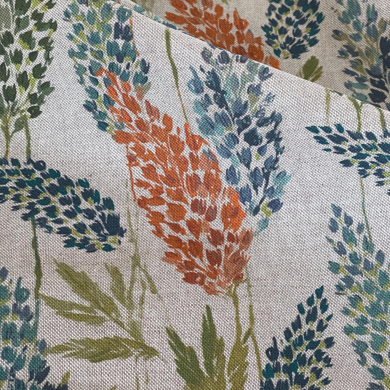 Detailed organic cotton textile with botanical meadow print in autumn tones for natural home decor and soft furnishings
