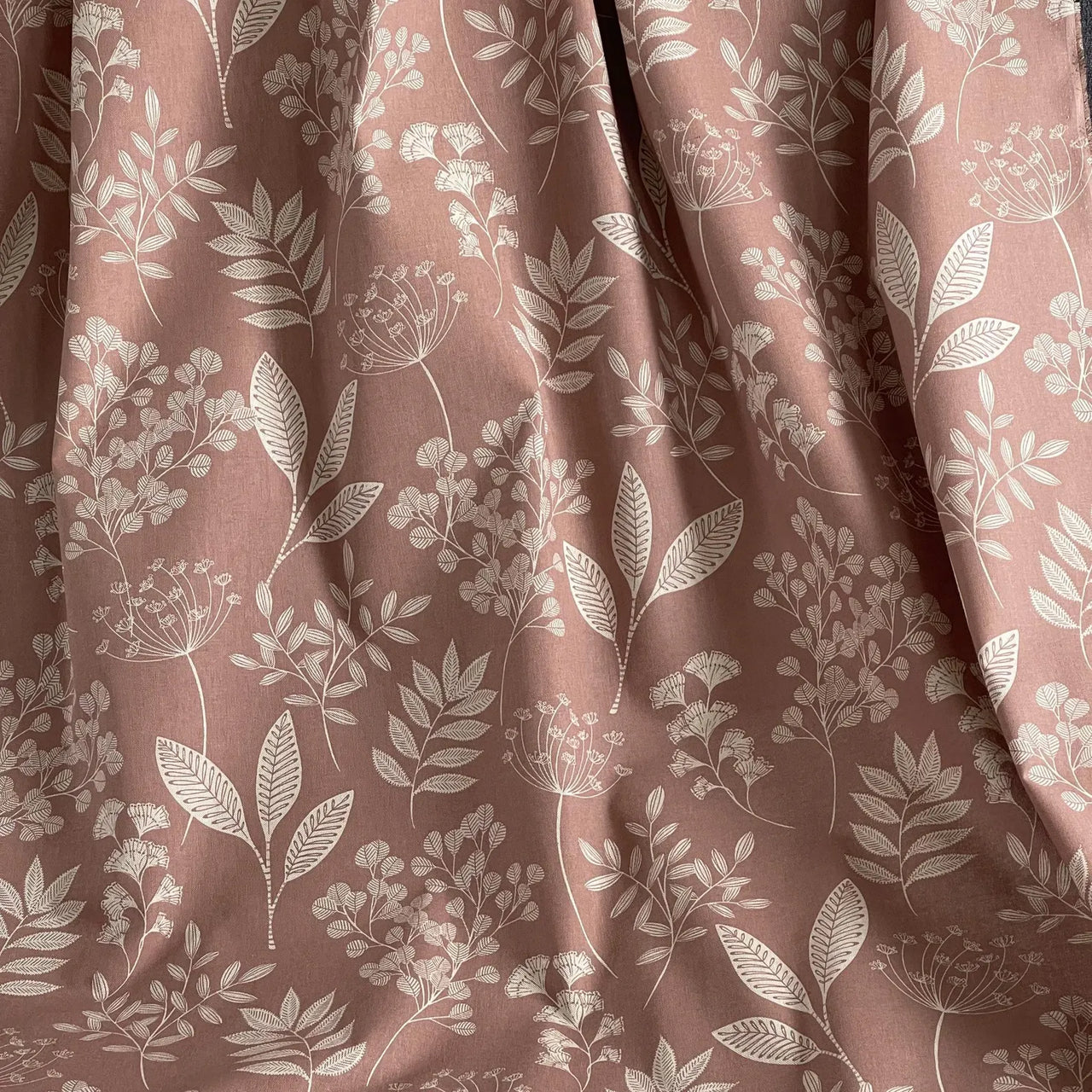 Rose pink woven fabric with soft neutral floral branches
